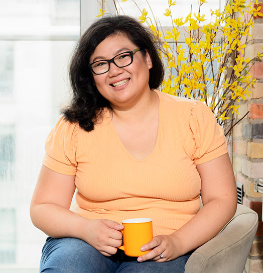 Picture of Veronica Yao, Career Coach, sitting holding a mug